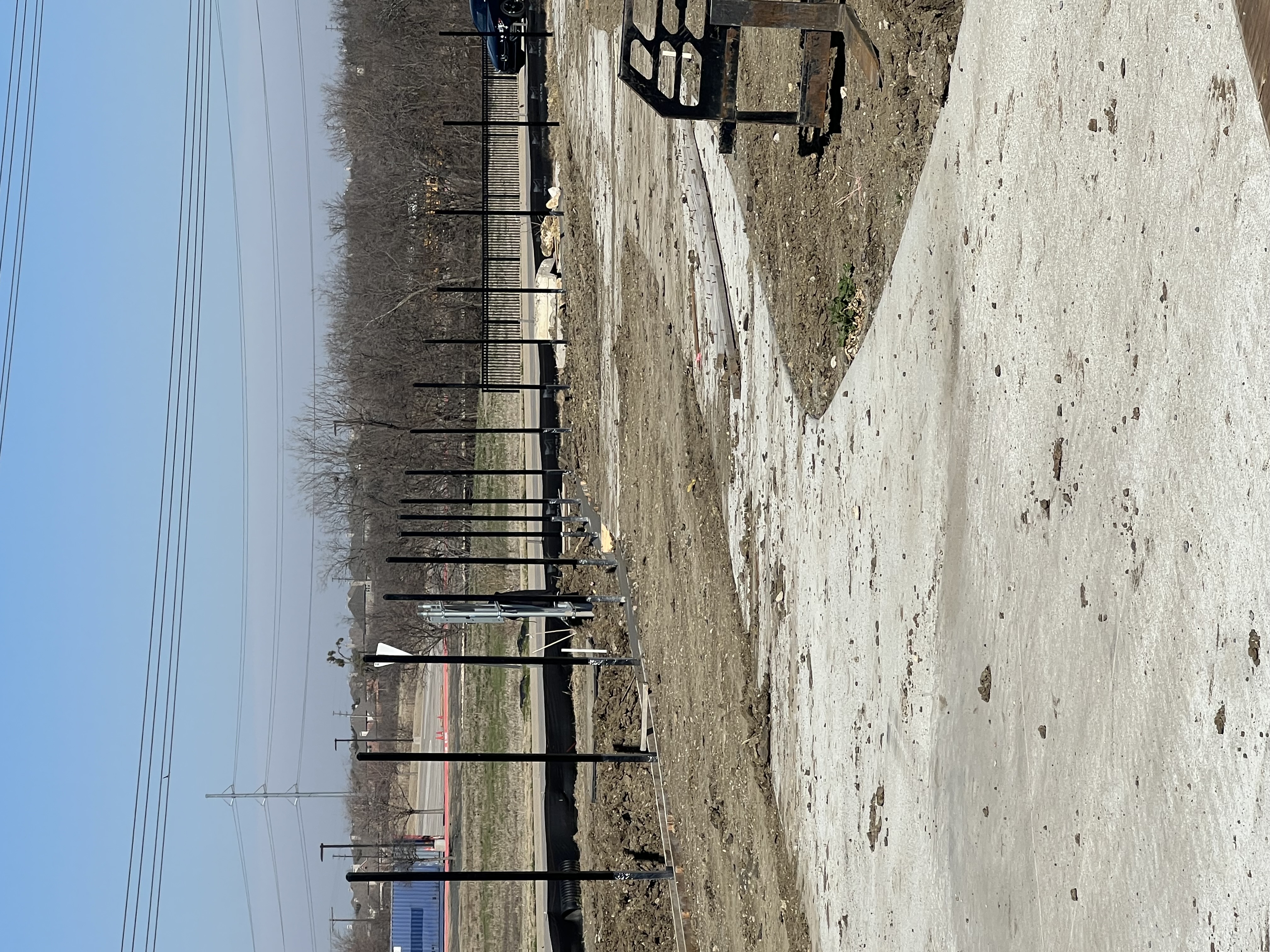 Chain link fence posts being set on commercial site
